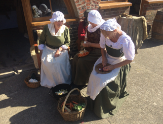 18th Century ladies preparing vegetables