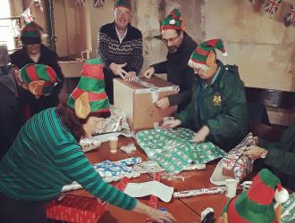Christmas elves busy wrapping presents