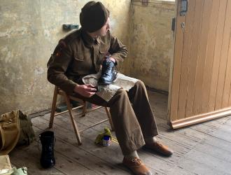 Close up of soldier polishing boots